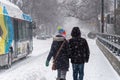 Pedestrians walking on Monkland Avenue during snow storm