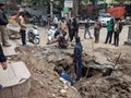 Pedestrians are watching the sewer digging work (Press Photograph)