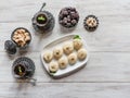 Pedha Indian sweet, Milk Fudge with tea cups in a white wooden table. Top view