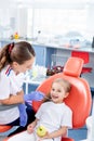 Pediatric dentist checks caries in a little girl. beautiful girl is smiling in dentist`s office. concept is a children`s medical