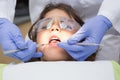 Pediatric dentist examining a little boys teeth in the dentists chair Royalty Free Stock Photo