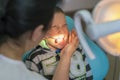 Pediatric dentist examining a little boys teeth in the dentists chair at the dental clinic. A child with a dentist in a dental Royalty Free Stock Photo
