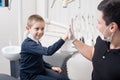 Pediatric dentist shake hands with young boy, congratulate patient for a successful treatment in dental office Royalty Free Stock Photo