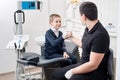 Pediatric dentist shake hands with young boy, congratulate patient for a successful treatment in dental office Royalty Free Stock Photo