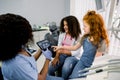 Pediatric dentistry. Two little girls patients, Caucasian and African, sitting in dentistry chair and pointing on the Royalty Free Stock Photo