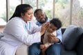 Pediatric doctor examining ear for a hearing test examining cute little girl in medical healthcare hospital or clinic. Smiling Royalty Free Stock Photo