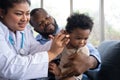 Pediatric doctor examining ear for a hearing test examining cute little girl in medical healthcare hospital or clinic. Smiling Royalty Free Stock Photo