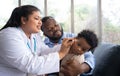 Pediatric doctor examining ear for a hearing test examining cute little girl in medical healthcare hospital or clinic. Smiling Royalty Free Stock Photo