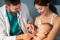 Pediatric doctor exams little baby. Health care, medical examination, people concept Royalty Free Stock Photo