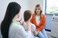 Pediatrician attentively listening to little girl lungs using stethoscope Royalty Free Stock Photo