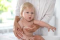 Pediatrician checking baby`s temperature in hospital, closeup.