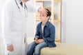 Pediatrician checking temperature of sick patient Royalty Free Stock Photo