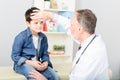 Pediatrician checking temperature of sick patient Royalty Free Stock Photo