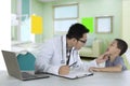 Pediatrician checking tongue of a patient in clinic