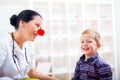 Pediatrician with clown nose and happy child patient Royalty Free Stock Photo