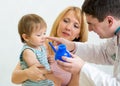 Pediatrician counseling mother and son about nasal irrigatio Royalty Free Stock Photo