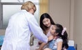 Pediatrician doctor doing vaccination of a little girl in hospital Royalty Free Stock Photo