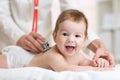 Pediatrician doctor examines baby with stethoscope Royalty Free Stock Photo