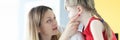 Pediatrician doctor examines little girl throat closeup