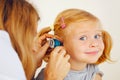 Pediatrician doctor examining girl