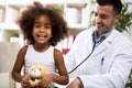 Pediatrician doctor examining kid