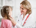Pediatrician doctor examining kid in her office Royalty Free Stock Photo