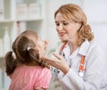 Pediatrician doctor examining kid's throat Royalty Free Stock Photo