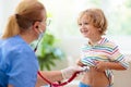 Doctor examining sick child in face mask Royalty Free Stock Photo