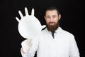 Pediatrician doctor holding inflated glove.