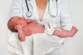 Pediatrician doctor is holding newborn baby in arms Royalty Free Stock Photo