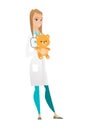 Pediatrician doctor holding teddy bear.