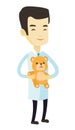 Pediatrician doctor holding teddy bear.