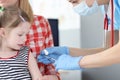 Pediatrician doctor inoculates little girl in shoulder Royalty Free Stock Photo