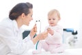 Pediatrician doctor showing baby stethoscope Royalty Free Stock Photo