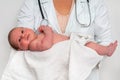 Pediatrician doctor is holding newborn baby in arms Royalty Free Stock Photo