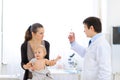 Pediatrician doctor with syringe and unhappy baby