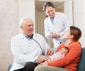 Pediatrician doctor talks with mother of newborn baby Royalty Free Stock Photo
