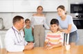 Pediatrician examinating pre-teen boy