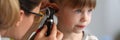 Pediatrician examines ear of sick child in office Royalty Free Stock Photo