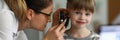 Pediatrician examines ear of sick child in office Royalty Free Stock Photo