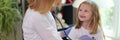 Pediatrician examines little girl with stethoscope closeup