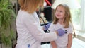 Pediatrician examines little girl with stethoscope closeup