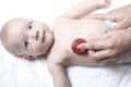 Pediatrician examines newborn baby boy with stethoscope Royalty Free Stock Photo