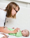 Pediatrician examines a newborn baby with a spatula