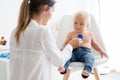 Pediatrician examining baby boy. Doctor using stethoscope to listen to kid Royalty Free Stock Photo