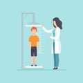 Pediatrician examining a boy in a medical office, doctor measuring the growth of a child, medical treatment and