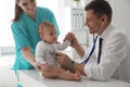 Pediatrician examining cute little baby in clinic Royalty Free Stock Photo