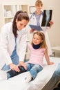 Pediatrician examining girl broken leg Royalty Free Stock Photo