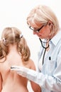 Pediatrician examining little girl