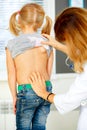 Pediatrician examining little girl